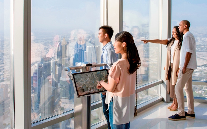 Visitors enjoying the view from Burj Khalifa Levels 124 & 125 observation deck in Dubai.