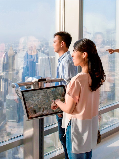 Visitors enjoying the view from Burj Khalifa Levels 124 & 125 observation deck in Dubai.
