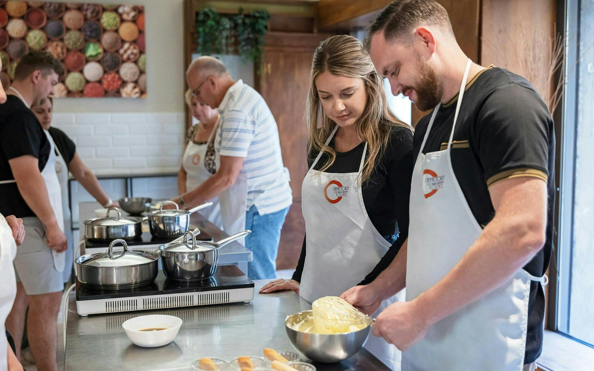 Small group cooking class in Florence with participants preparing dishes.