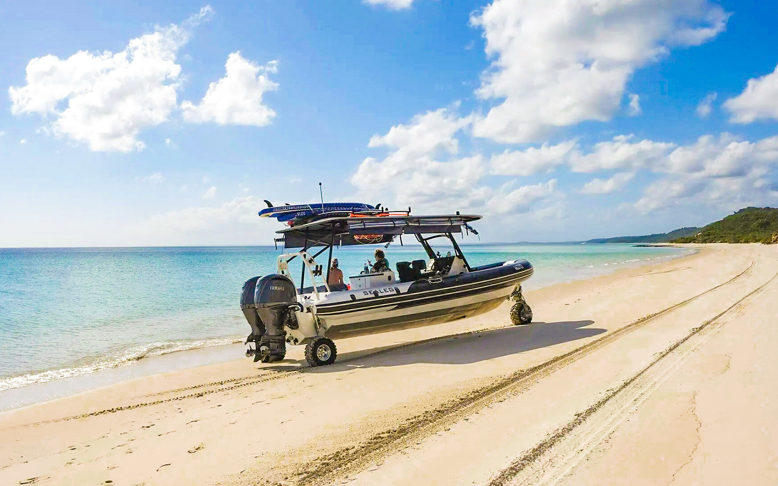 Sealegs boat on K'gari beach, Fraser Island, near turquoise water.