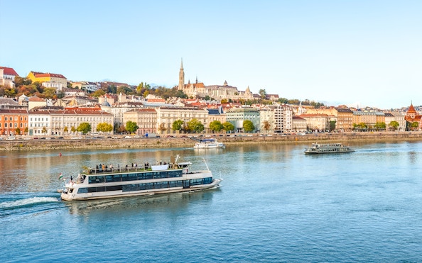 Budapest river cruise with cityscape view, including historic buildings and boats on the Danube.