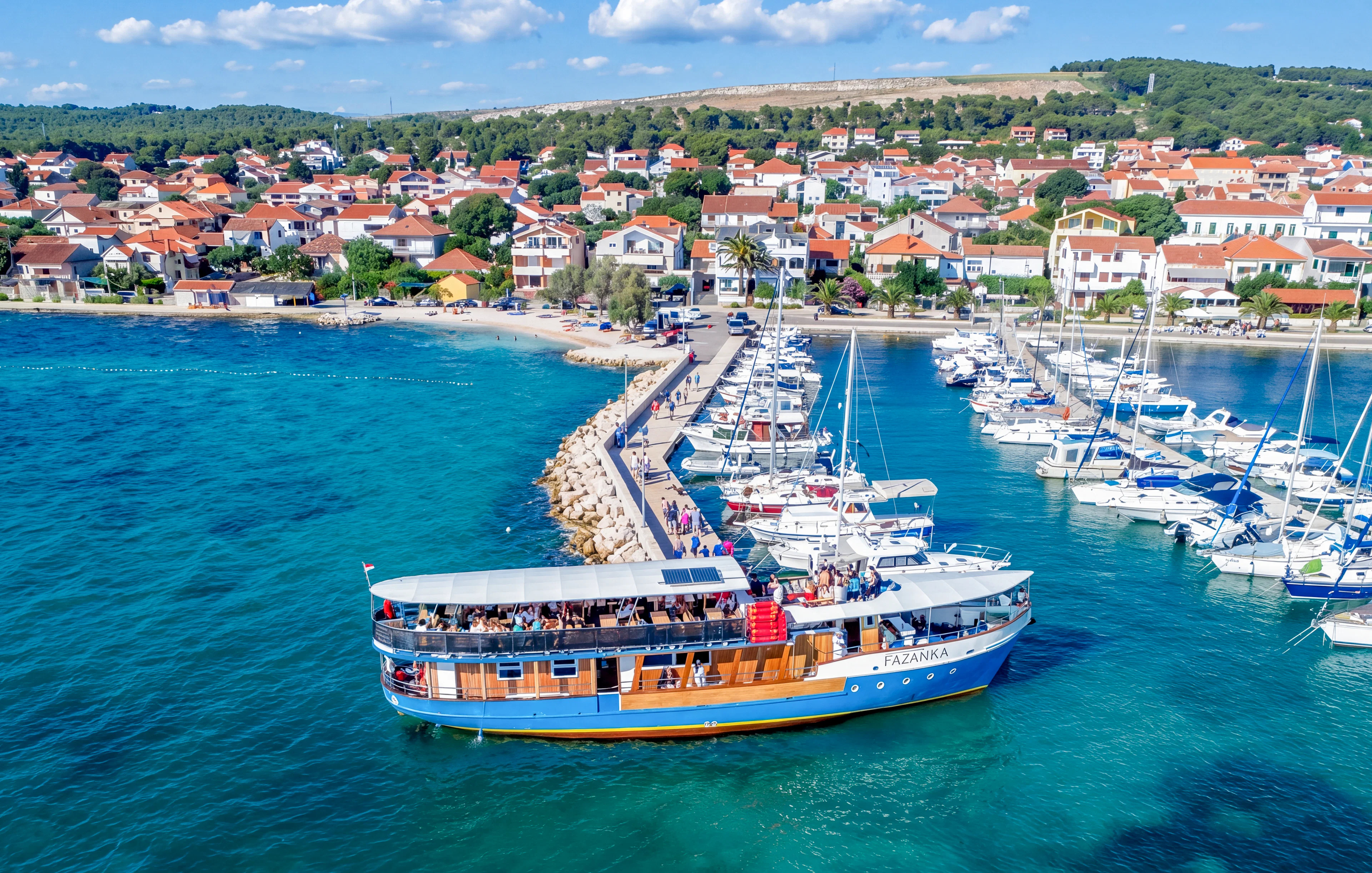 Boat Franzka departing from Zadar, Croatia, with marina and coastal town in background.