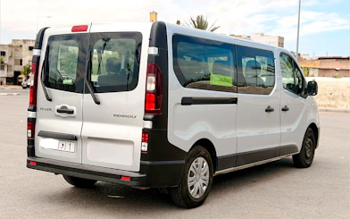 Van for airport transfers in Marrakech, parked in urban setting.