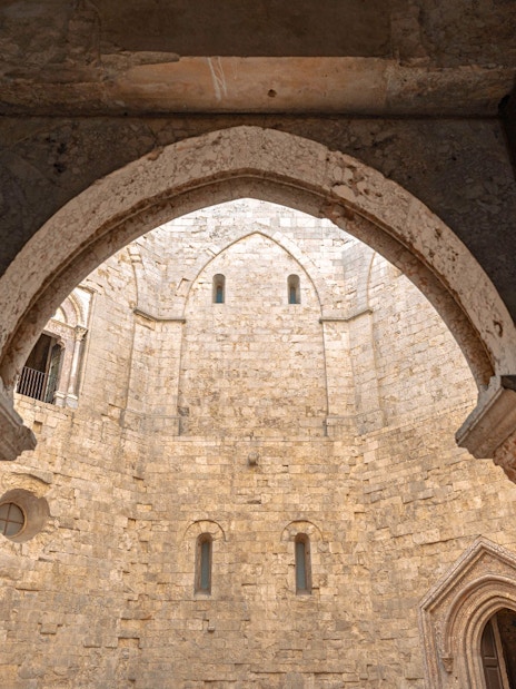 Interior view of Castel del Monte's stone courtyard, showcasing medieval architecture.