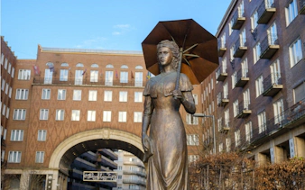 Statue of a woman with an umbrella in Budapest's Jewish Quarter.