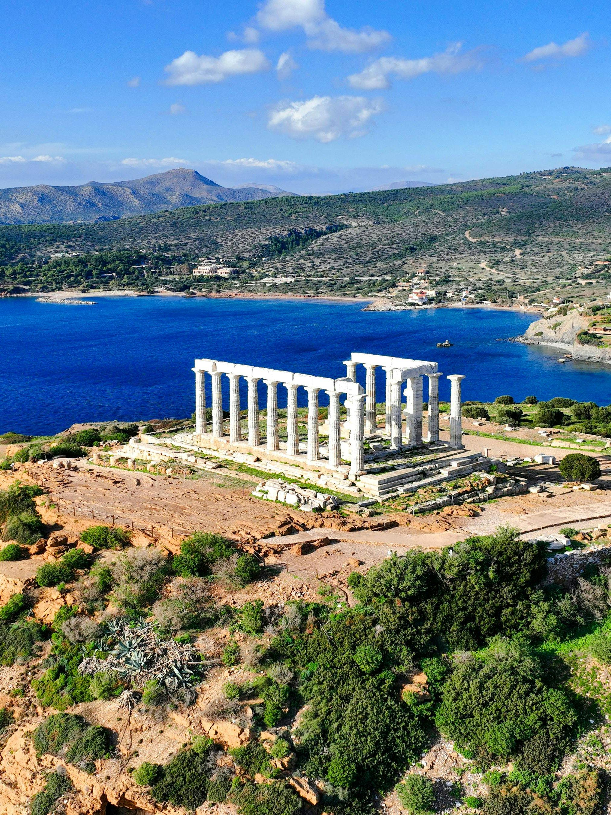 Aerial view of Temple of Poseidon at Cape Sounio, Greece, overlooking the Aegean Sea.