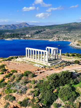 Aerial view of Temple of Poseidon at Cape Sounio, Greece, overlooking the Aegean Sea.