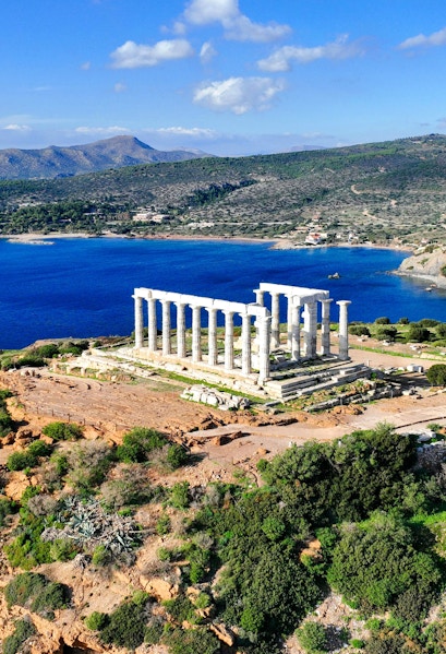 Aerial view of Temple of Poseidon at Cape Sounio, Greece, overlooking the Aegean Sea.
