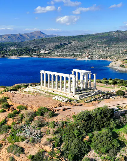 Aerial view of Temple of Poseidon at Cape Sounio, Greece, overlooking the Aegean Sea.