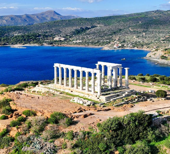 Aerial view of Temple of Poseidon at Cape Sounio, Greece, overlooking the Aegean Sea.