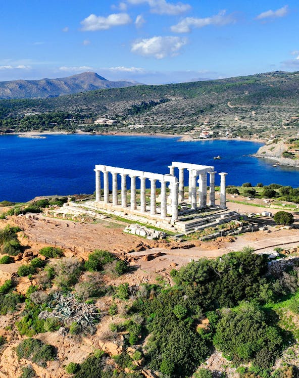 Aerial view of Temple of Poseidon at Cape Sounio, Greece, overlooking the Aegean Sea.