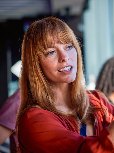 Visitor taking a photo at Melbourne Skydeck with city view in background.