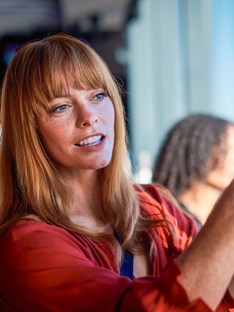 Visitor taking a photo at Melbourne Skydeck with city view in background.