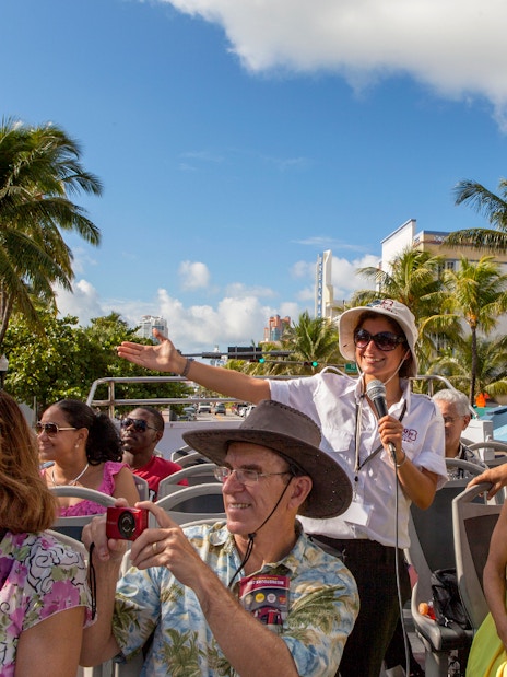 Group enjoying a guided tour on a Hop On Hop Off bus in sunny Miami.
