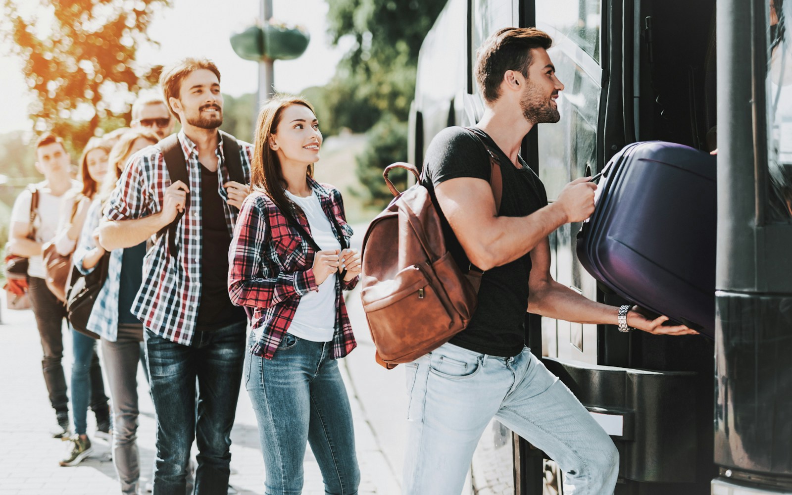 Travelers boarding shuttle bus at Shinjuku station for Tokyo Disney Resort trip.