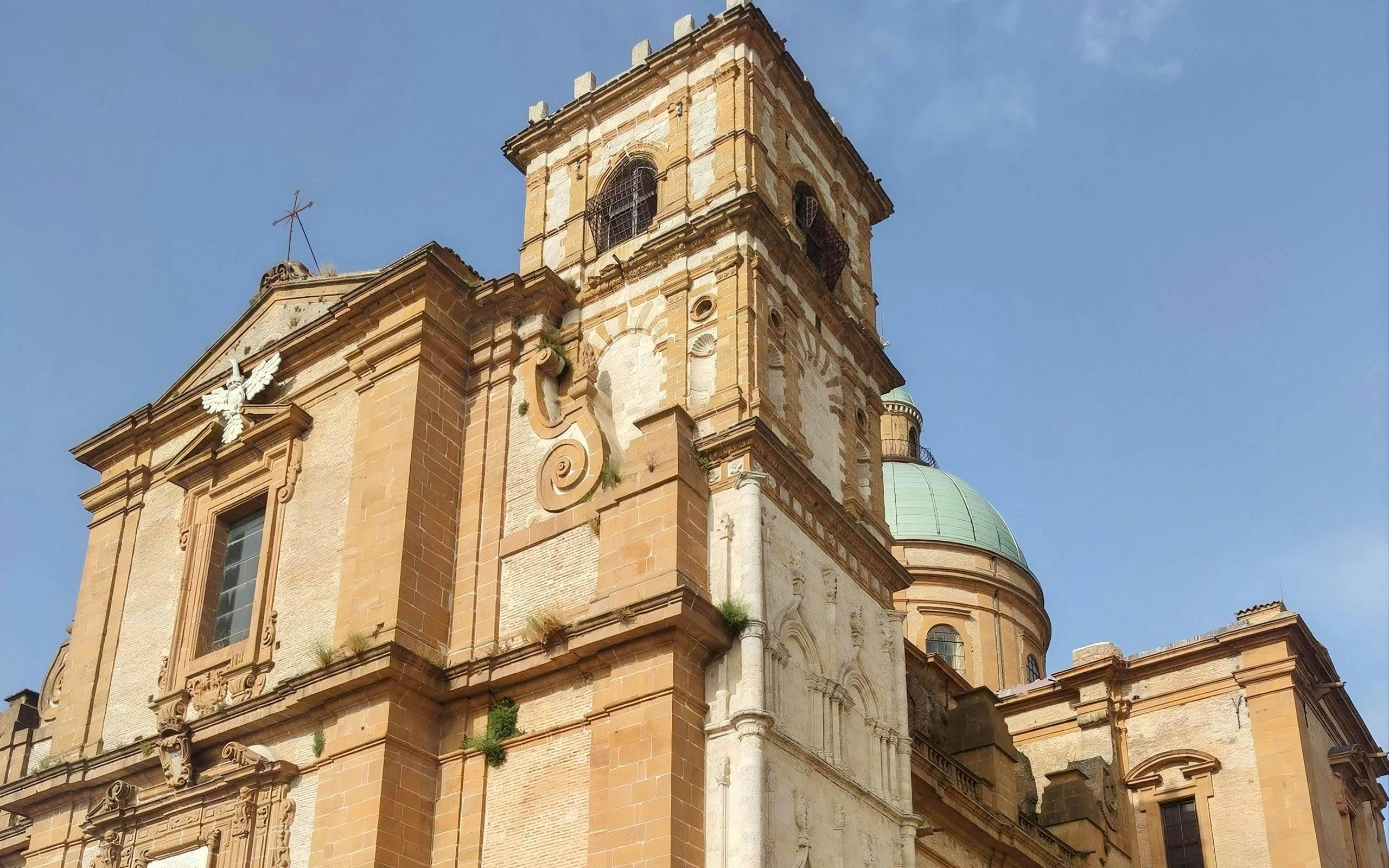 Piazza Armerina Cathedral facade with bell tower and dome under clear sky.