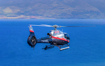 Helicopter flying over ocean near Maui, Hawaii during island tour.