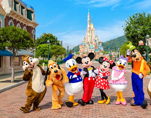 Disney characters on Main Street with castle in background, Disneyland Hong Kong.