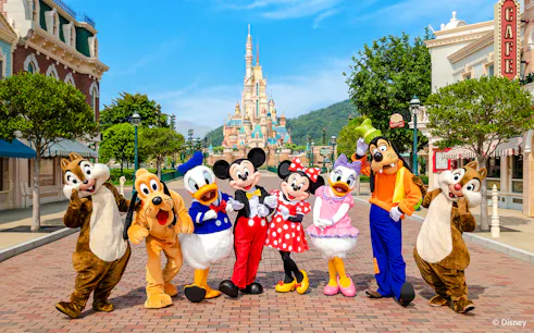 Disney characters on Main Street with castle in background, Disneyland Hong Kong.