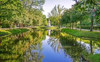 Reflective pond and trees in Tiergarten Park, Berlin.