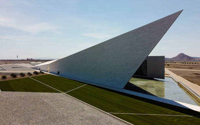 Oman Across Ages Museum with modern angular architecture and landscaped grounds.
