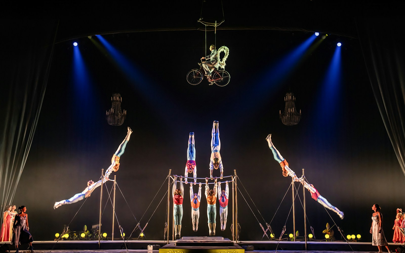 Cirque du Soleil performers in vibrant costumes on stage during Corteo show.