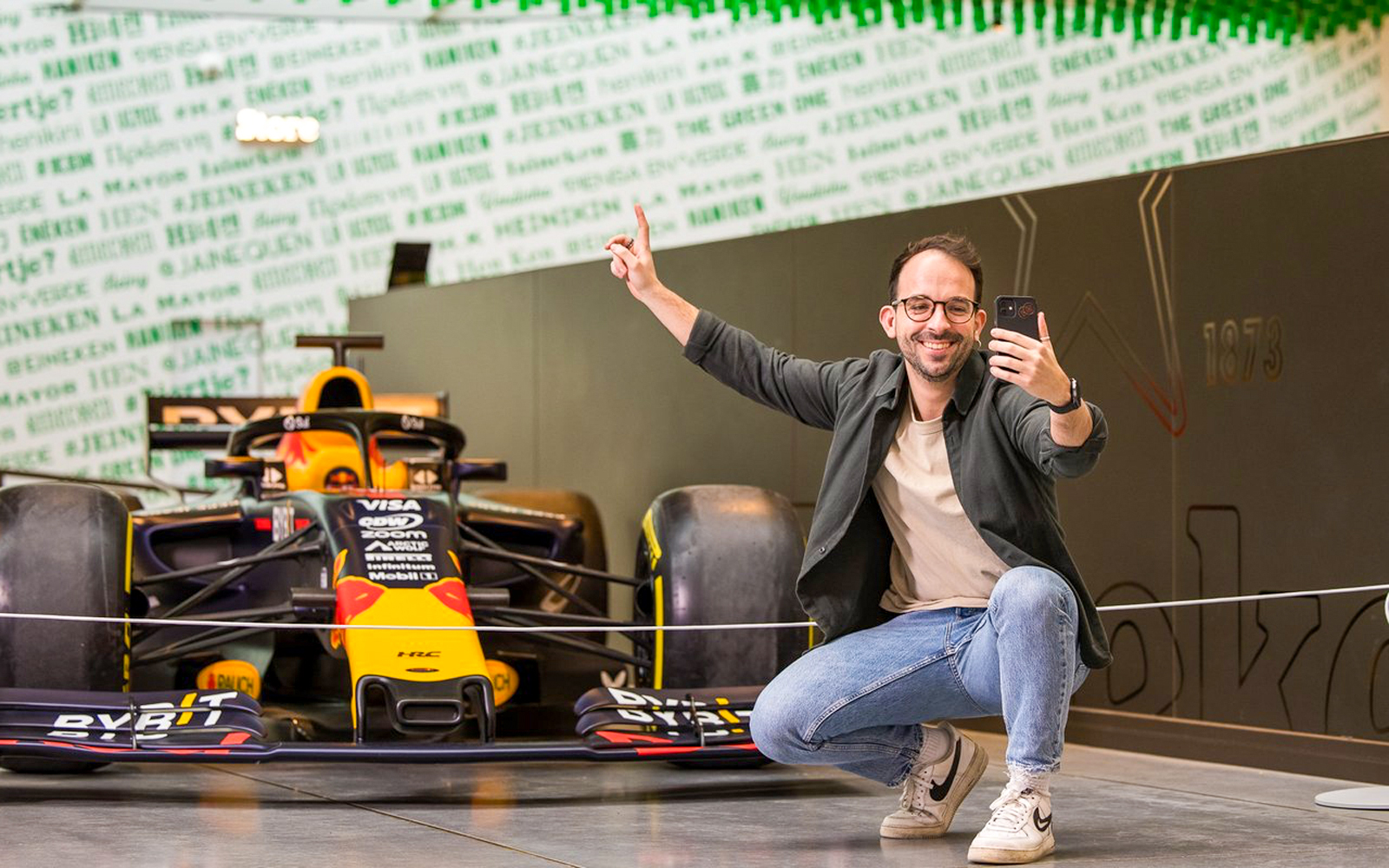 Heineken Experience tour entrance in Amsterdam with visitors exploring brewery exhibits.