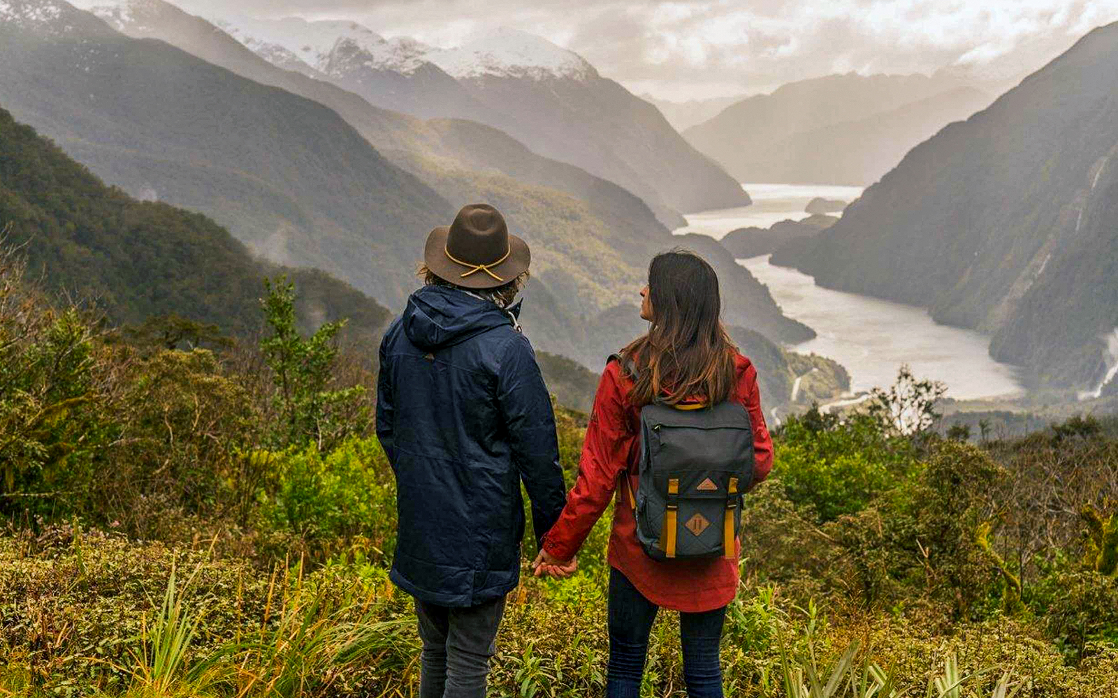 Couple overlooking Doubtful Sound fjord from Te Anau on an overnight cruise.