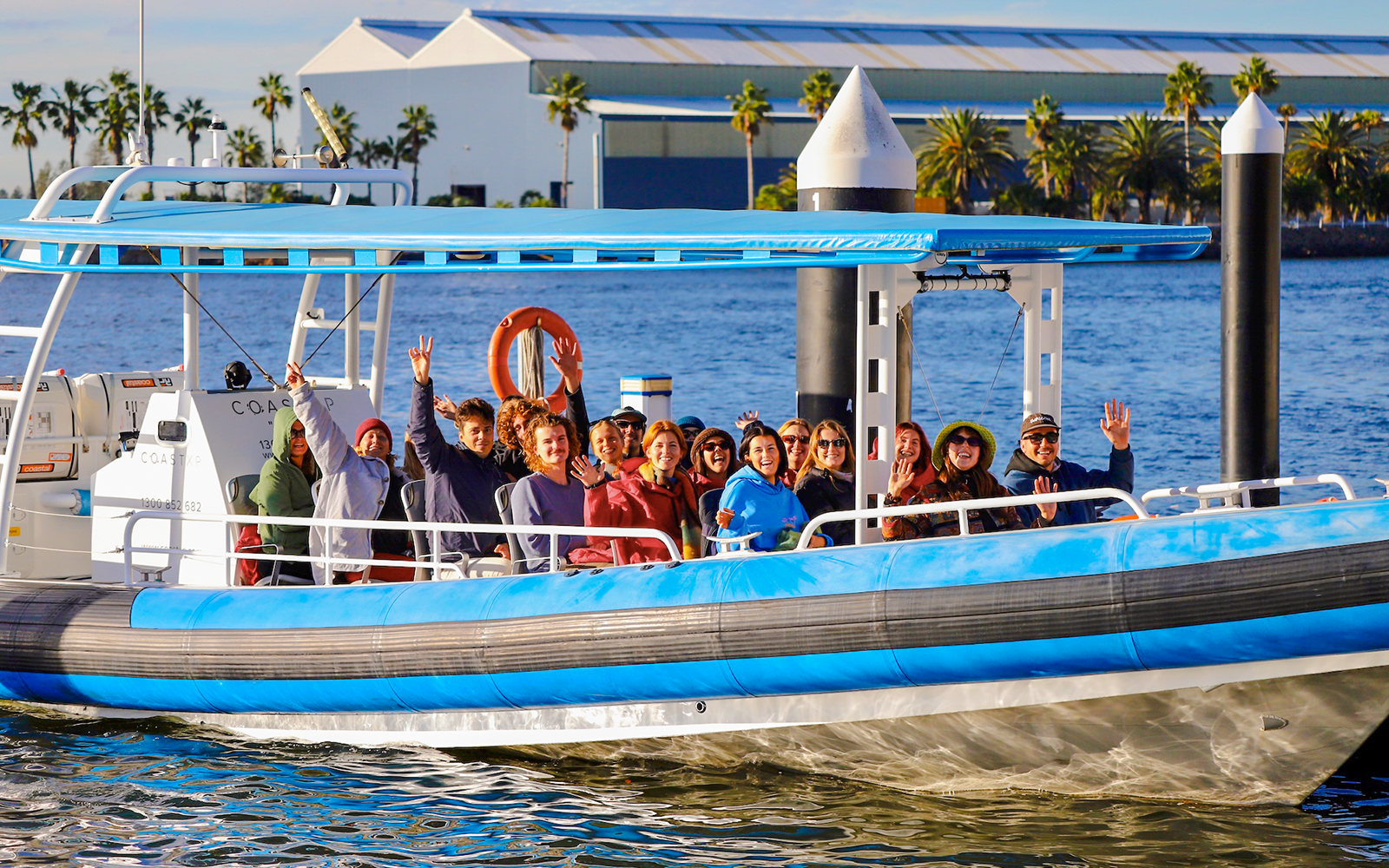 Group enjoying whale watching tour on a boat in Newcastle, Australia.