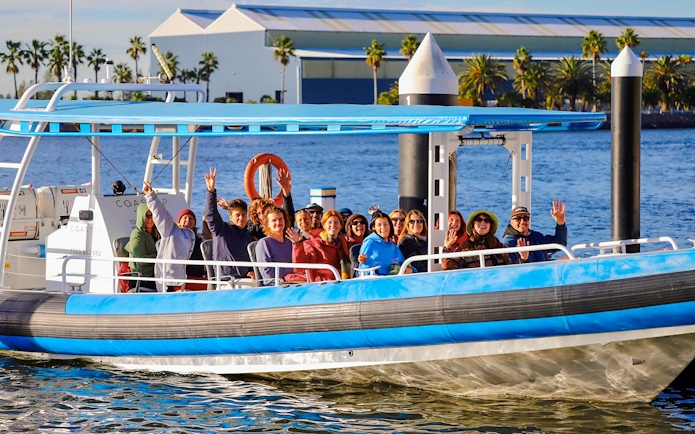Group enjoying whale watching tour on a boat in Newcastle, Australia.