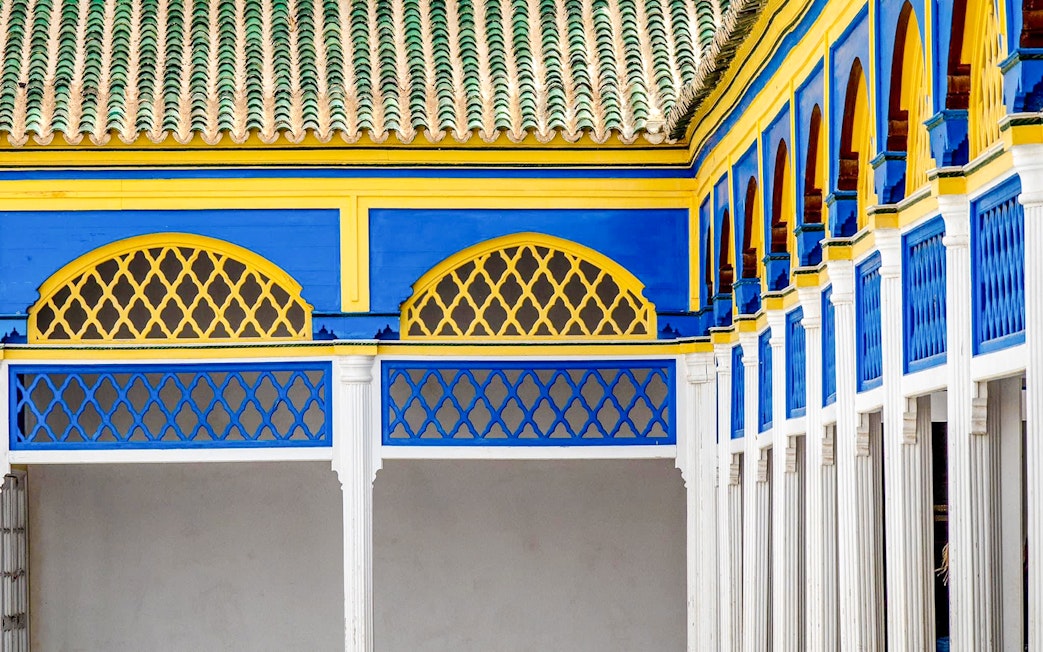 Wall tiles and colorful arches in Bahia Palace, Marrakech, Morocco.