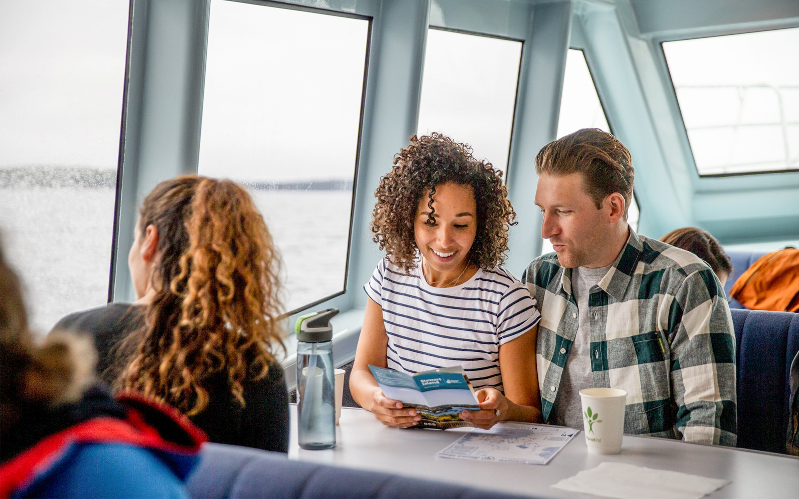 Couple reading brochure on ferry to Ulva Island.