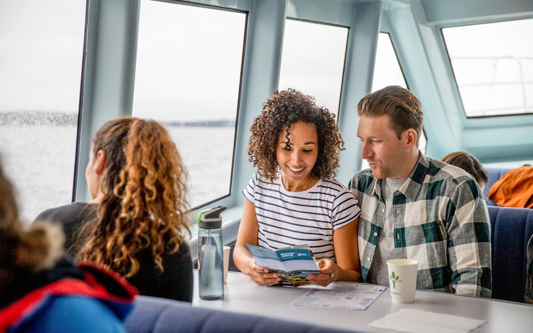 Couple reading brochure on ferry to Ulva Island.