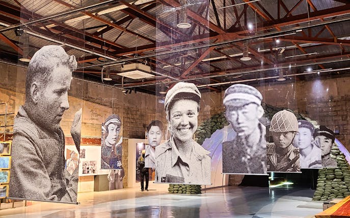 Hanging portraits of soldiers at DMZ museum exhibit in Paju, South Korea.