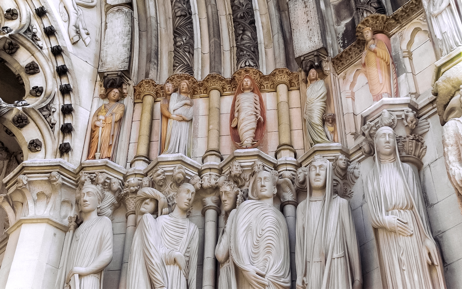 Stone sculptures on St. Patrick's Cathedral facade, showcasing detailed religious figures.