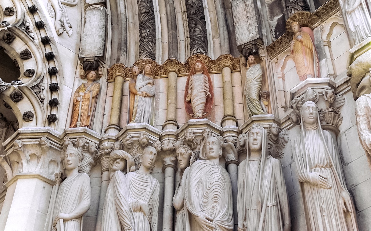 Stone sculptures on St. Patrick's Cathedral facade, showcasing detailed religious figures.