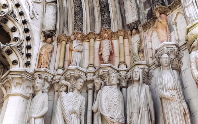Stone sculptures on St. Patrick's Cathedral facade, showcasing detailed religious figures.