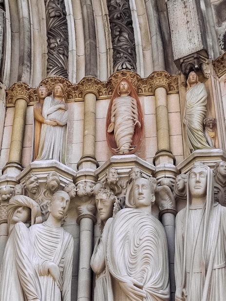Stone sculptures on St. Patrick's Cathedral facade, showcasing detailed religious figures.
