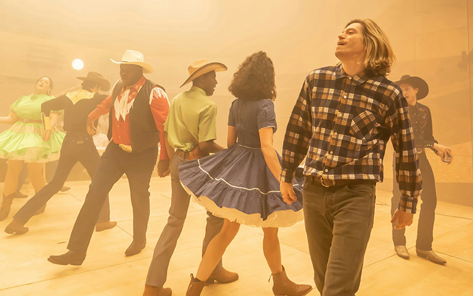 Dancers in cowboy attire performing in a scene from the musical Oklahoma!