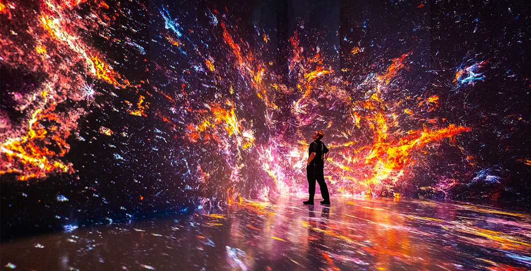 Immersive digital art installation at ARTECHOUSE, New York with vibrant cosmic visuals.