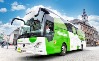 Flibco airport transfer bus in a European city square.