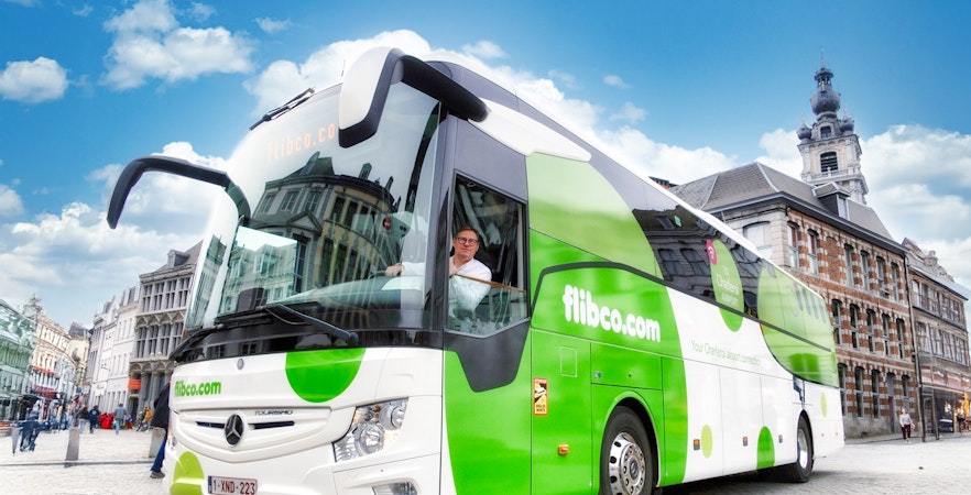 Flibco airport transfer bus in a European city square.