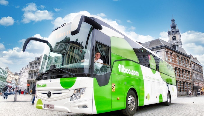 Flibco airport transfer bus in a European city square.