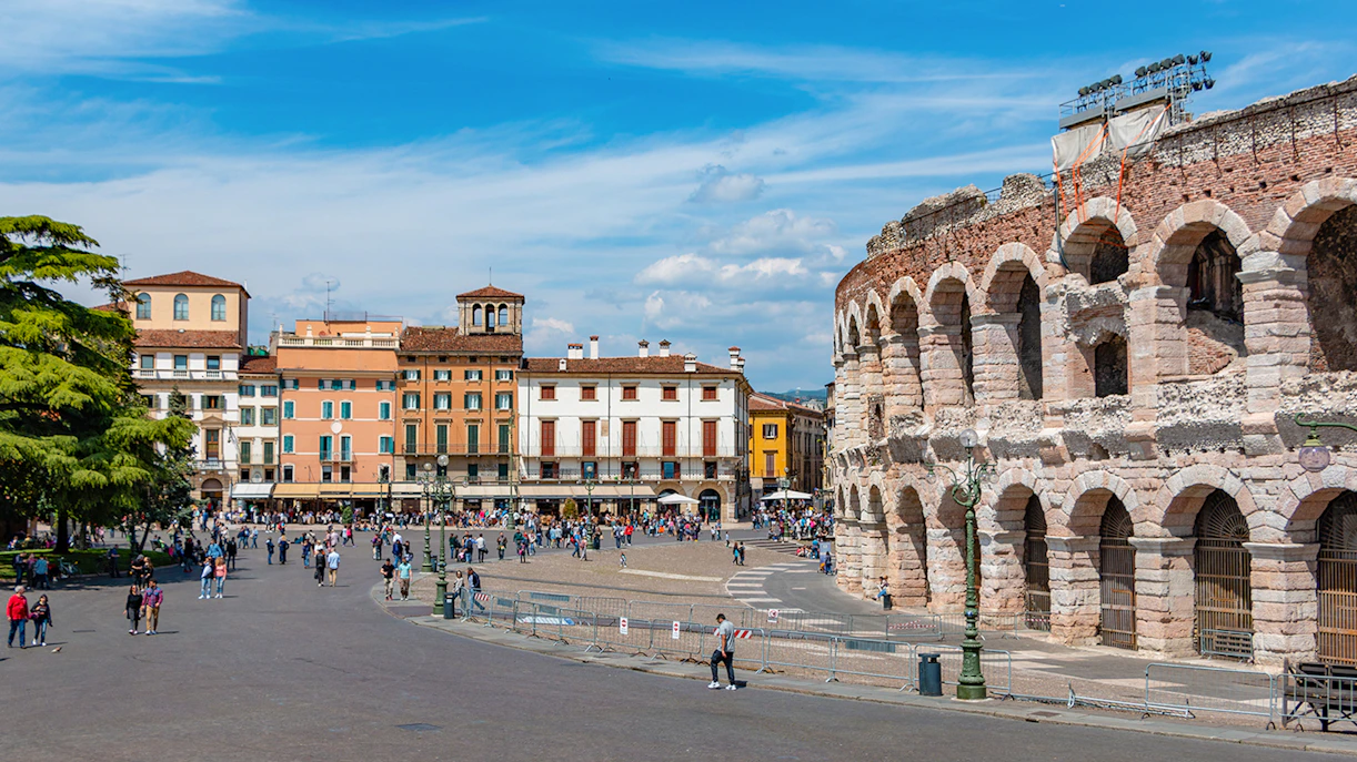 Verona Arena with surrounding plaza and colorful buildings in Verona, Italy.