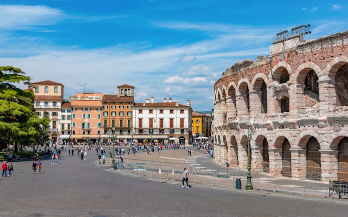 Verona Arena with surrounding plaza and colorful buildings in Verona, Italy.