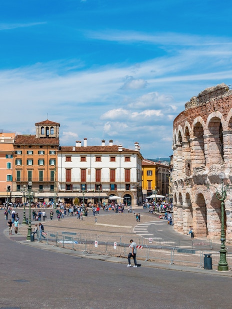 Verona Arena with surrounding plaza and colorful buildings in Verona, Italy.