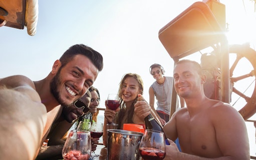 Group enjoying drinks on a sunset cruise along the Amalfi Coast.