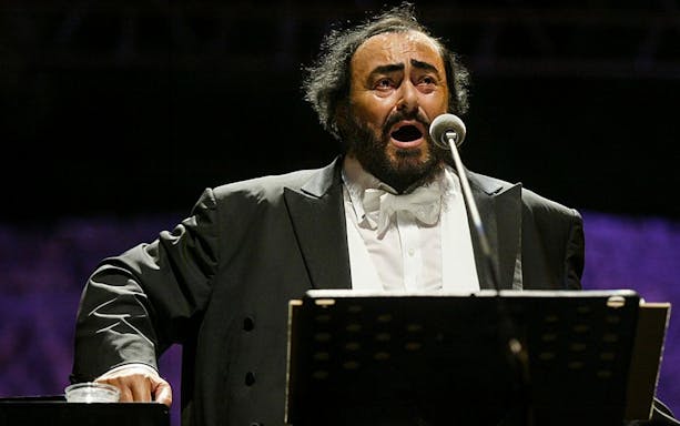 Opera singer performing on stage, related to Luciano Pavarotti House Museum.