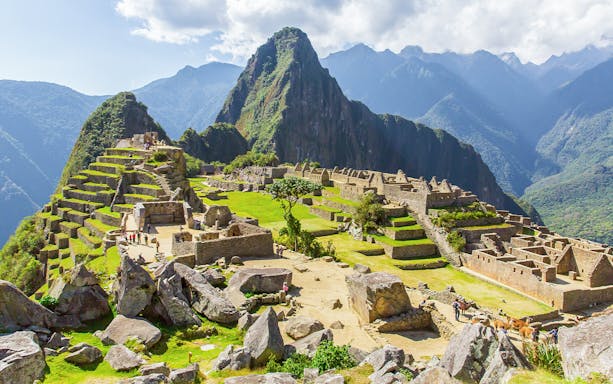 Main plaza of Machu Picchu with ancient stone structures and surrounding mountain landscape.