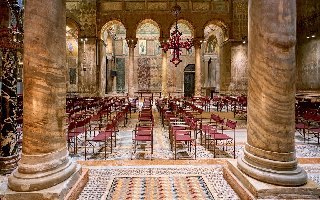 Tourists inside St. Mark's Basilica admiring its architecture, Venice, Italy.